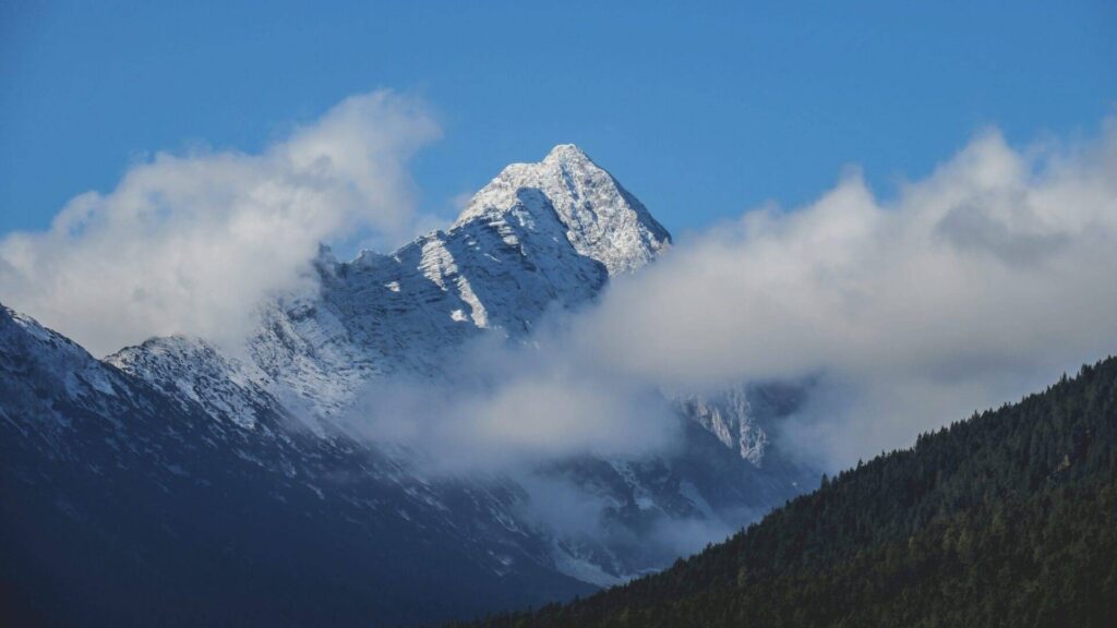 Snow-covered mountain peak above the clouds