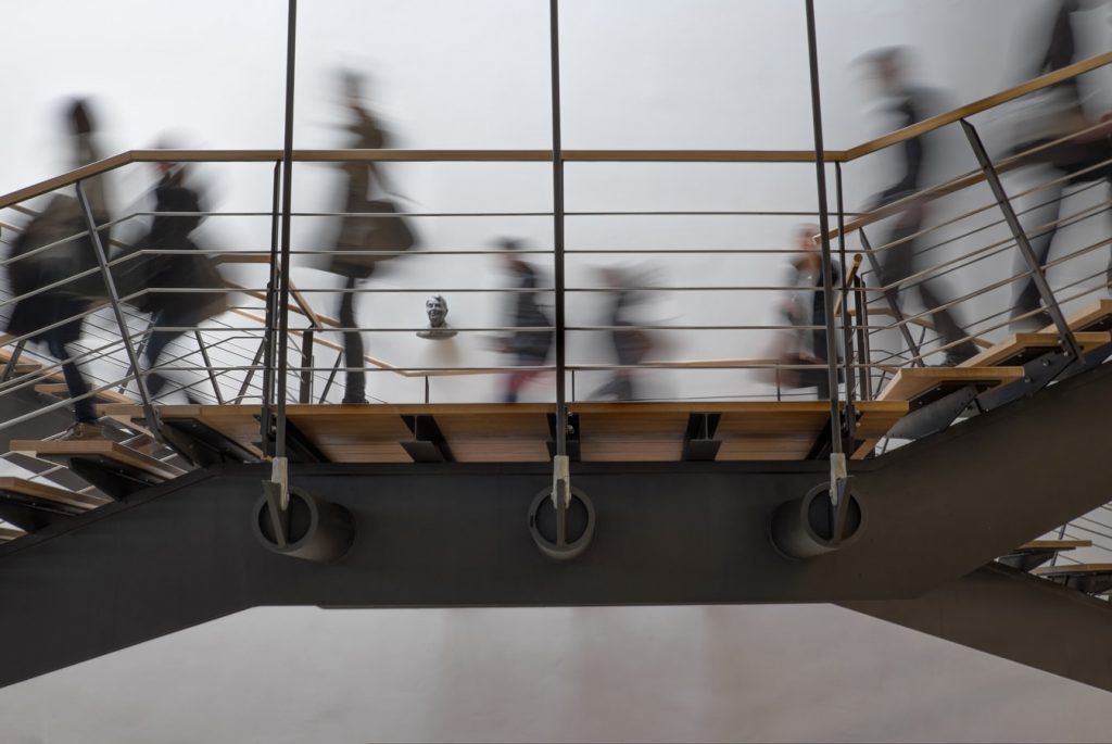 People walking on an indoor staircase